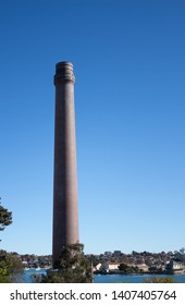 Factory Brick Smoke Stack Against Blue Sky Set On Cockatoo Island Sydney Harbour Australia
