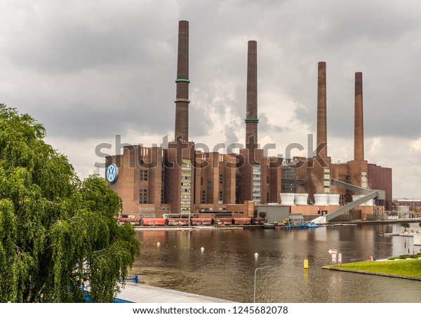 The factory of the car\
manufacturer VW Volkswagen in Wolfsburg, Germany, June 15, 2018,\
with the four chimneys at the harbour basin at the\
Mittellandkanal