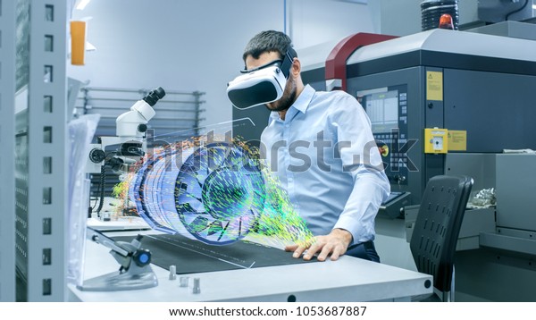 Factory Chief Engineer Wearing VR\
Headset Designs Engine Turbine on the Holographic Projection Table.\
 Futuristic Design of Virtual Mixed Reality\
Application.