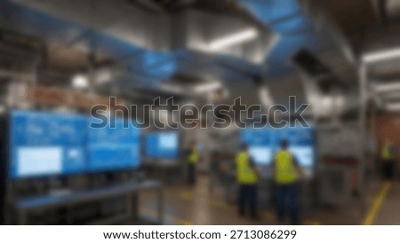 Factory Control Team Monitors HighTech Screens in Modern Industrial Space.