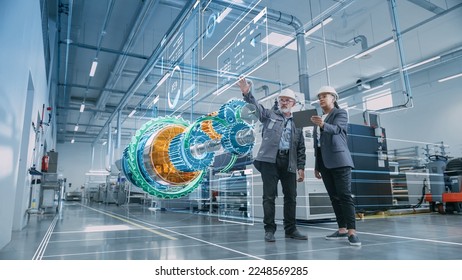 Factory Digitalization: Two Industrial Engineers Use Tablet Computer, Visualize 3D Model of Clean Green Energy Engine. Industry 4 High-Tech Electronics Facility with Machinery Manufacturing Products - Shutterstock ID 2248569285