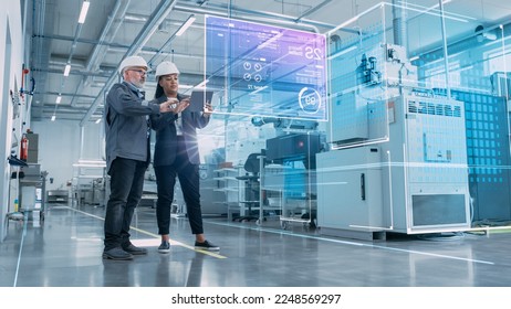 Factory Digitalization: Two Industrial Engineers Use Tablet Computer, Big Data Statistics Visualization, Optimization of High-Tech Electronics Facility. Industry 4.0 Machinery Manufacturing Products