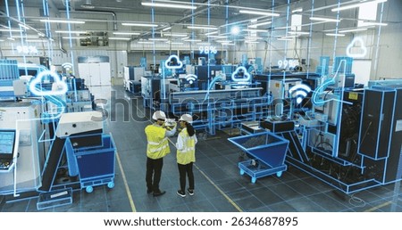 Factory Digitalization: Two Industrial Engineers Use Tablet Computer, Big Data Statistics Visualization, Optimization of High-Tech Electronics Facility. Industry Four Machinery Manufacturing Products