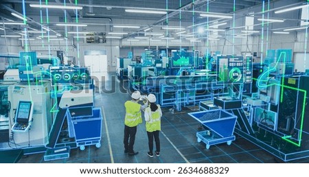 Factory Digitalization: Two Industrial Engineers Use Tablet Computer, Big Data Statistics Visualization, Optimization of High-Tech Electronics Facility. Industry Four Machinery Manufacturing Products