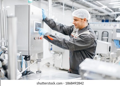 Factory engineer man operating machine control panel in dairy milk production plant. - Powered by Shutterstock