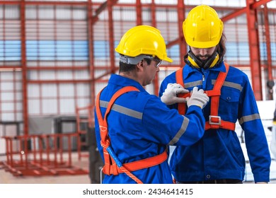 Factory engineer man wearing safety gears for young colleague worker  - Powered by Shutterstock