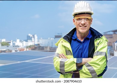 Factory Engineer Senior Man Standing Confidence At Rooftop Of Solar Cell Panel In Background. Operation On Site Renewable Energy Construction.