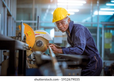 Factory engineer wearing safety uniform control operating lathe grinding machine working in industry factory. - Powered by Shutterstock