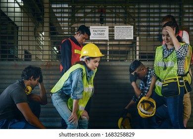 factory engineer and workers at factory gate with layoff annoucement of factory closed due to economics crisis and recession with depressed of unemployment, economics problem from economics recession