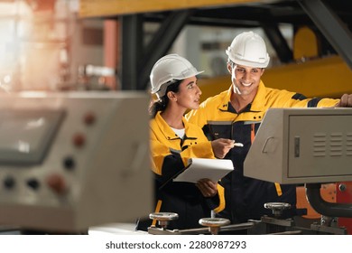 factory engineering manager teaching female mechanic trainee for job training and apprentice. young apprentices in technical vocational training are taught by older trainers on a cnc lathes machine