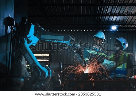 factory engineers using smart control to control the arm robot machine for cutting the metal sheet. specialist Worker working at height technology industry for produce the electronic part device.