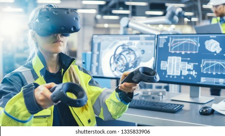 Factory: Female Industrial Engineer Wearing Virtual Reality Headset and Holding Controllers, She Uses VR technology for Industrial Design, Development and Prototyping in CAD Software.
