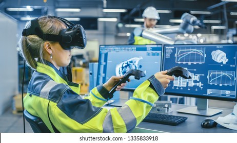 Factory: Female Industrial Engineer Wearing Virtual Reality Headset and Holding Controllers, She Uses VR technology for Industrial Design, Development and Prototyping in CAD Software. - Powered by Shutterstock