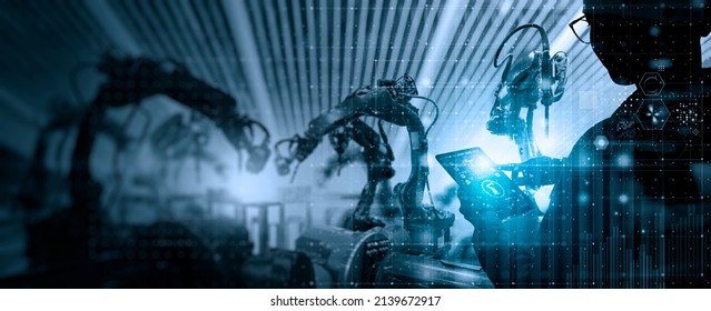 Factory Female Industrial Engineer working with automation robot arms machine in intelligent factory industrial on real time monitoring system software.Digital future manufacture. - Shutterstock ID 2139672917