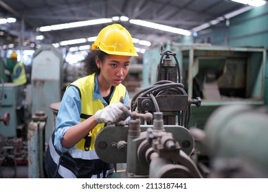 Factory Female Industrial Engineer Works in metal working factory, Inside the Heavy Industry. Portrait of working female industry technical worker or engineer woman working in an industrial. - Shutterstock ID 2113187441