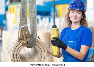 Factory female worker moving high voltage transformer coil with gantry crane at manufacture workshop - Powered by Shutterstock