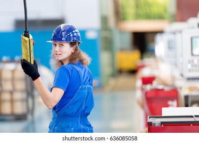 Factory female worker operating workshop gantry crane - Powered by Shutterstock