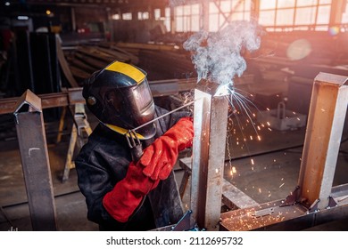 Factory industrial weld worker in workplace with spark. Professional welder erecting metal steel. - Powered by Shutterstock