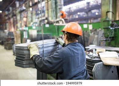 Factory Industrial Worker Transporting Cargo with Workshop Overhead Crane - Powered by Shutterstock