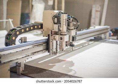 Factory large CNC digital cutter machine for cutting fabric textile material - Powered by Shutterstock