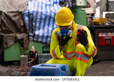 Factory male worker wear safety uniform and safety gas mask opening chemical tank at the industry factory. Chemical specialist wear safety gas mask working and checking chemical tank at work factory 