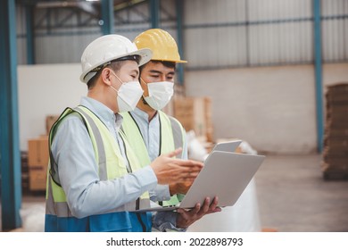 Factory Manager And Engineer In  Medical Mask And Safety Protective Suite Using Computer Laptop And Digital Tablet Working Discuss Together