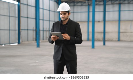 Factory Manager Using Tablet Computer In Warehouse Or Factory . Industry And Supply Chain Management Concept .