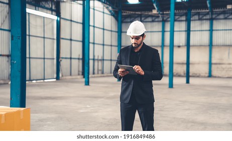 Factory Manager Using Tablet Computer In Warehouse Or Factory . Industry And Supply Chain Management Concept .