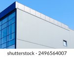 factory office architecture building exterior outdoor facade blue wall and window with blue sky background with empty copy space for text