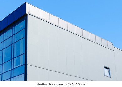 factory office architecture building exterior outdoor facade blue wall and window with blue sky background with empty copy space for text - Powered by Shutterstock