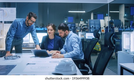 Factory Office Meeting Room: Team of Engineers Gather Around Conference Table, They Discuss Project Blueprints, Inspect Mechanism, Find Solutions, Use Laptop. Industrial Technology Factory - Shutterstock ID 1936499938
