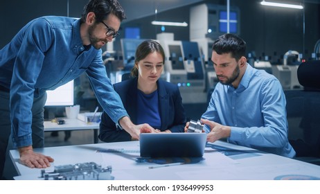 Factory Office Meeting Room: Team of Engineers Gather Around Conference Table, They Discuss Project Blueprints, Inspect Mechanism, Find Solutions, Use Laptop. Industrial Technology Factory - Shutterstock ID 1936499953