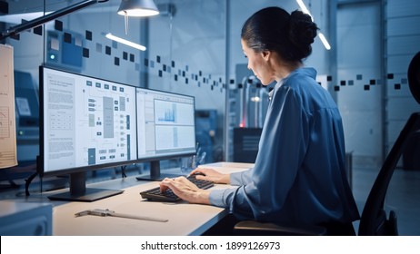 Factory Office: Portrait of Beautiful and Confident Female Industrial Engineer Working on Computer, on Screen Industrial Electronics Design Software. High Tech Facility with CNC Machinery