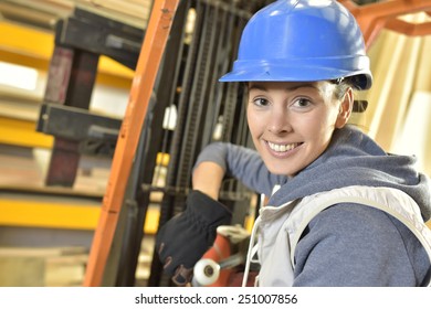 Factory operator in warehouse using storage vehicle