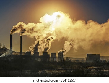 Factory pipe polluting air, smoke from chimneys against sun, environmental problems, ecological theme, industry scene - Shutterstock ID 534462514