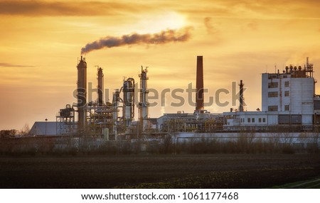Factory pipe polluting air, smoke from chimneys against sun, environmental problems, ecological theme, industry scene
