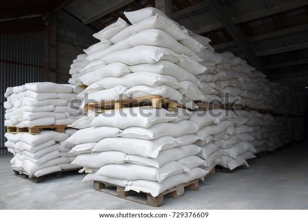 Factory premises warehouse, bags of ingredients\
stacked on pallets
