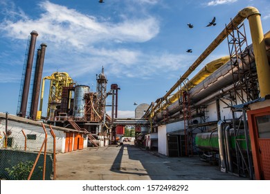 Factory for processing forest products under blue sky.