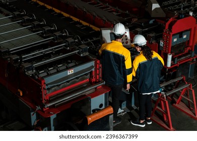 Factory quality control inspector conduct safety inspection on steel machinery and manufacturing process. Engineer or operator make optimization in heavy industry. Top wide view Exemplifying - Shutterstock ID 2396367399