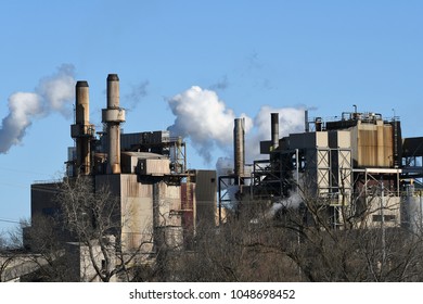 Factory with smoke and clouds