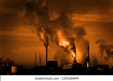 Factory smokestack chimney piping smoke or steam into the air pollution