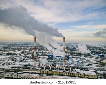 Factory smokestack emissions at cloud winter snow landscape, climate change and global warming for the environment concept.