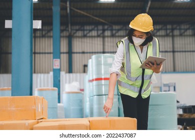 Factory Woman Staff In Medical Face Mask And Protective Safety Using Digital Tablet Working Checking Inventory Storage At Textile Warehouse