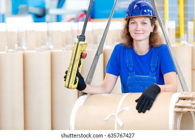 Factory woman worker moving high voltage transformer coil with workshop overhead crane - Powered by Shutterstock