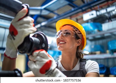 Factory Worker Checking Quality Of Metal Parts For Automobile Industry.