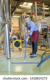 A Factory Worker Cleaning Floor