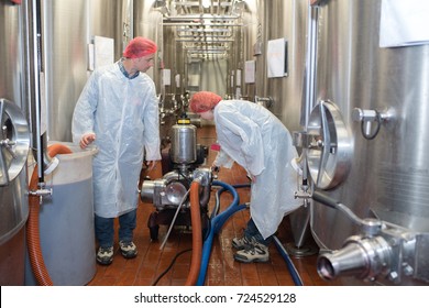 Factory Worker Cleaning Floor