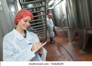 Factory Worker Cleaning Floor