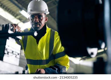 Factory worker or engineer do machine job in adept manufacturing workshop . Industrial people and manufacturing labor concept .
