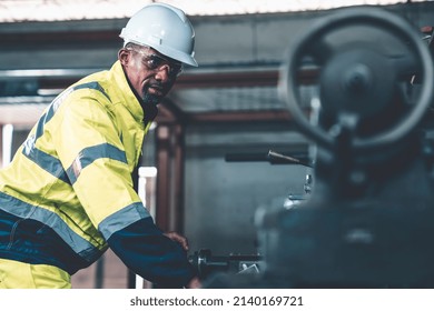 Factory worker or engineer do machine job in adept manufacturing workshop . Industrial people and manufacturing labor concept .